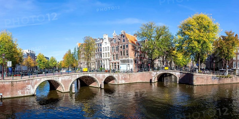Canals and bridges building panorama at the Keizersgracht in the city of Amsterdam, Netherlands