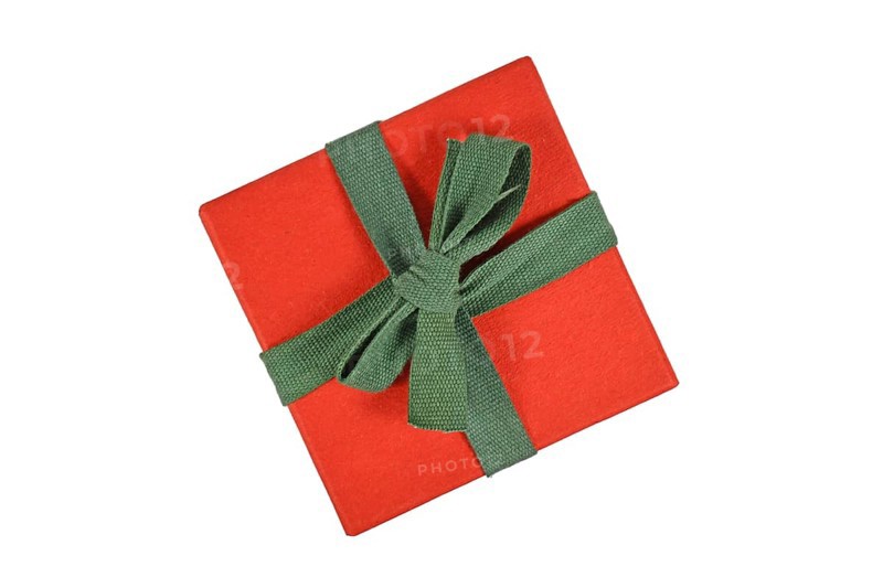 Top view of red Christmas gift box with green ribbon on white background