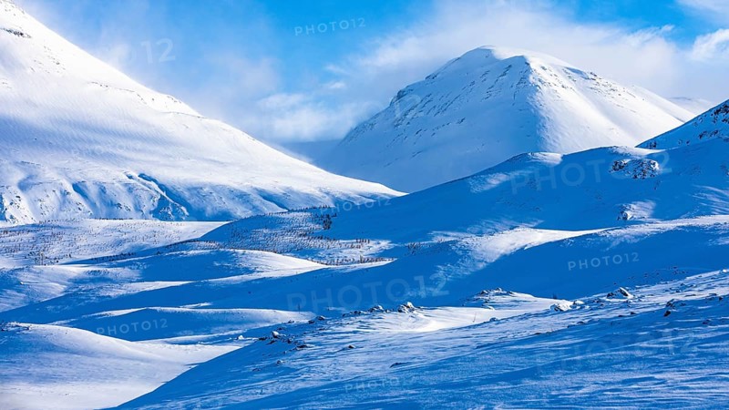 Light and shadow over snowy hilly landscape, near Akureyri, Northern Iceland Eyestra, Iceland, Europe