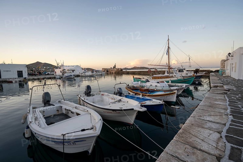 Fishing boats in the harbour of Naoussa at sunset, White Cycladic houses, Naoussa, Paros, Cyclades, Greece, Europe
