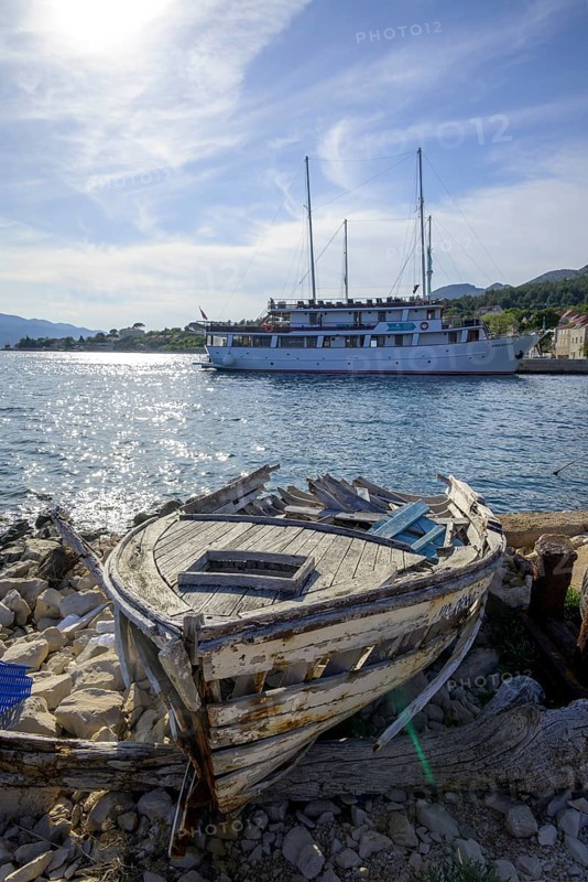 Old boat and behind it ship Meridijan, Kucište, Orebic, Pelješac Peninsula, Dubrovnik-Neretva County, Croatia, Europe