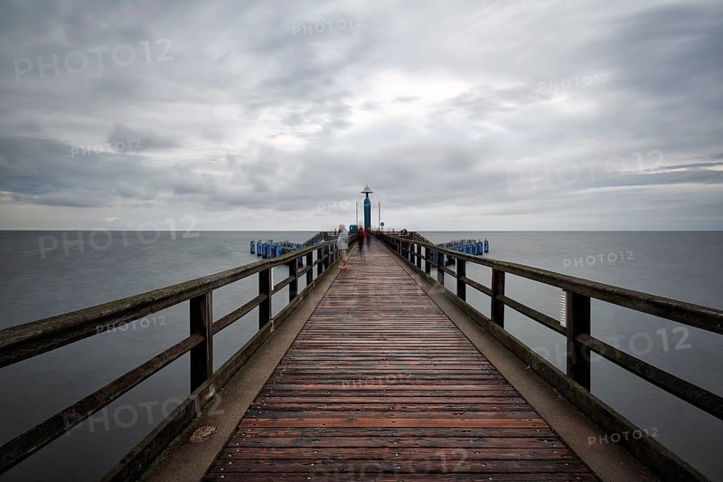 Pier Sellin with single tourists in front of diving gondola, rainy weather at the Baltic Sea, long exposure, Baltic resort Sellin, island Rügen, Mecklenburg-Western Pomerania, Germany, Europe