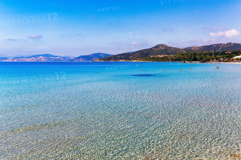 Turquoise blue clear water, coastline with hills on the horizon, L'Île-Rousse, Ile Rousse, Mediterranean Sea, Corsica, France, Europe