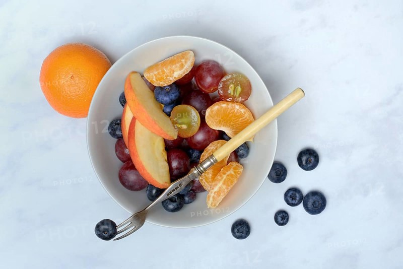 Various pieces of fruit in bowl, fruit salad