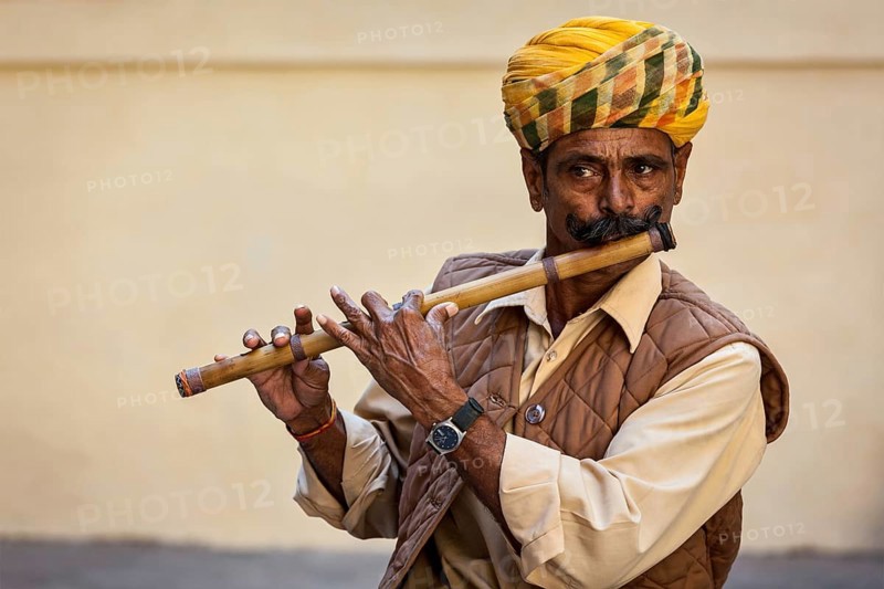 JODHPUR, INDIA, NOVEMBER 26, 2012: Indian man plays wooden flute in Mehrangarh fort, Rajashtan, India, Asia