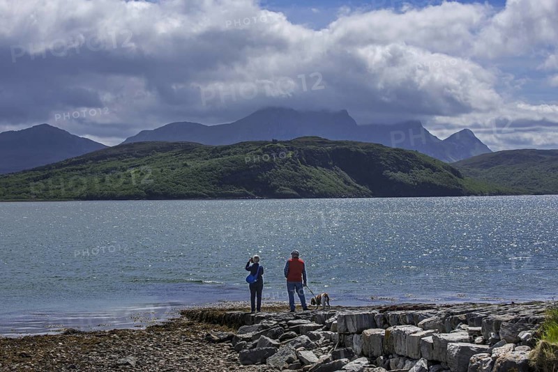 Tourists looking over Ben Loyal and Kyle of Tongue, shallow sea loch in northwest Highland, Sutherland, Scottish Highlands, Scotland, UK