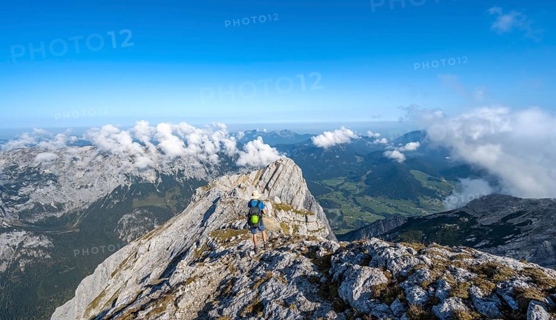 Mountaineer on a rocky narrow mountain path with mountain panorama, mountain tour to the summit of the Hochkalter, Hochkalter crossing, Berchtesgaden Alps, Bavaria, Germany, Europe