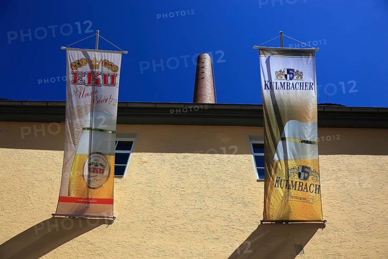 Advertising flags of the Kulmbacher Brewery and the (former) EKU Brewery, which was taken over by Kulmbacher, in Kulmbach, Upper Franconia, Bavaria, Germany (editorial use only)