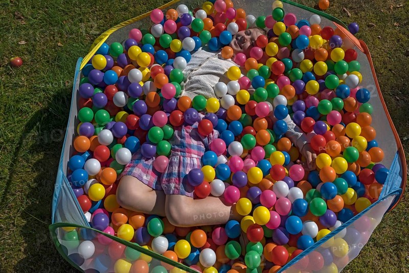 Little girl in a colourful ball pool, Lower Saxony, Germany, Europe