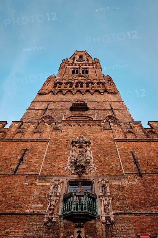 Brugge Belfry tower facade of famous tourist destination at Grote markt square in Bruges, Belgium on sunset