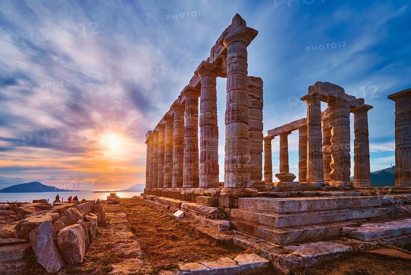 Greece Cape Sounio. Ruins of an ancient temple of Poseidon, Greek god of the sea, on sunset. Shot of temple ruins on sunset. Tourist landmark of Attica, Sounion, Greece, Europe