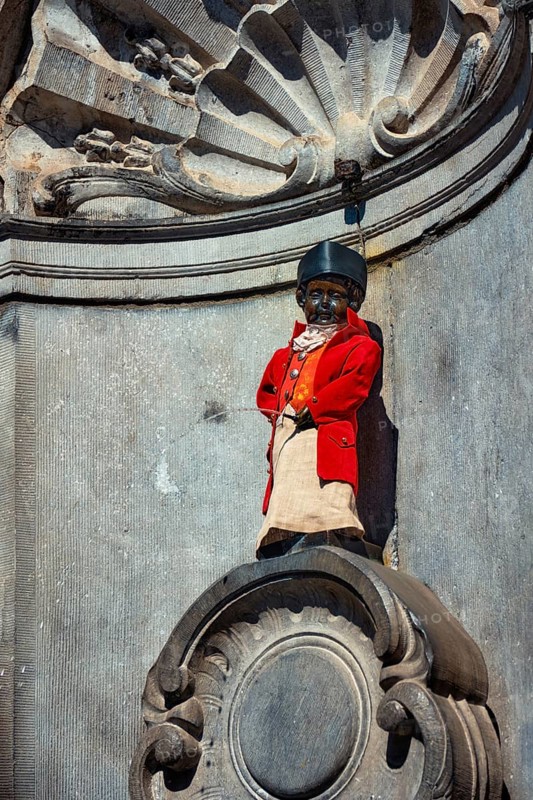 Brussels, Belgium, May 29, 2018: Famous tourist attraction of Brussels, dressed Manneken Pis statue fountain in Brussels. Statue of a pissing boy dressed in clothes in Bruxelles, Belgium, Europe