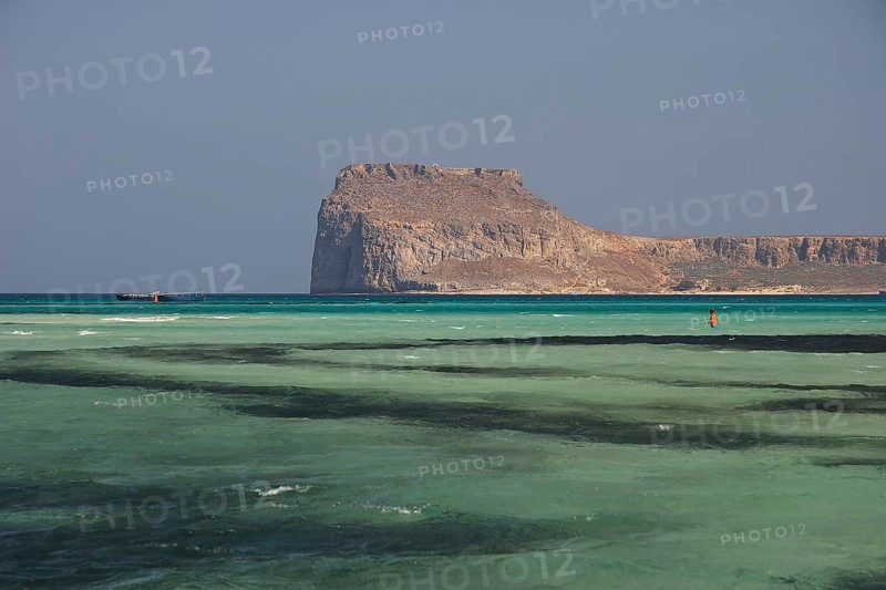 Lagoon, green sea, ship, tourist in the water, Venetian sea fortress Gramvoussa, peninsula Gramvoussa, pirate bay, Balos, Tigani, blue cloudless sky, West Crete, island Crete, Greece, Europe
