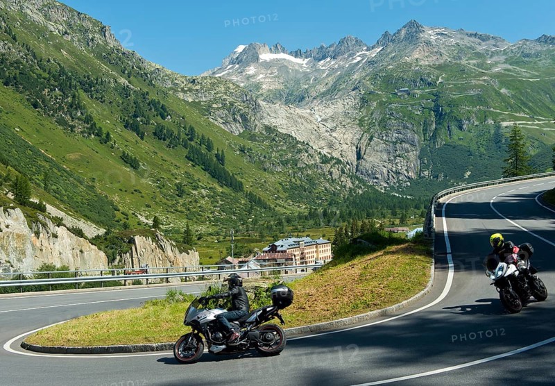 Traffic on the pass road to the Furka Pass near Gletsch, in the background the headwaters of the Rhone in the ice-free steep former ground moraine of the Rhone glacier, Gletsch, Goms, Valais, Switzerland, Europe