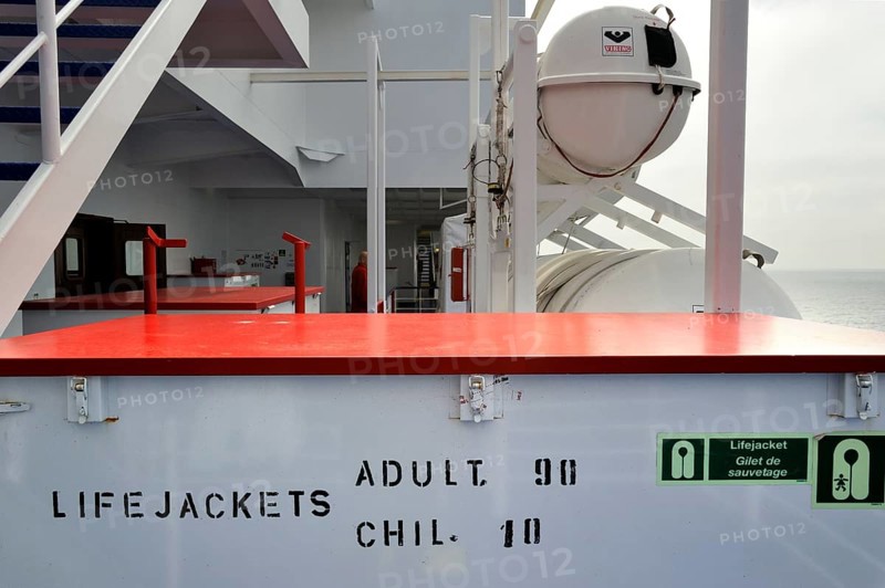 Box of life jackets and inflatable life rafts in hard-shell canisters on board a ferry boat