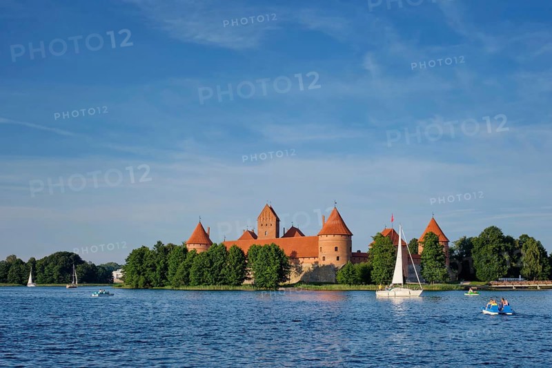 Trakai Island Castle in lake Galve with boats and yachts in summer day with beautiful sky, Lithuania. Trakai Castle is one of major tourist attractions of Lituania