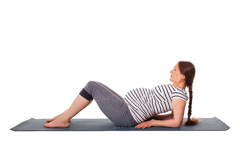 Pregnancy yoga exercise, pregnant woman doing yoga asana Purvottanasana Upward Plank Pose isolated on white background