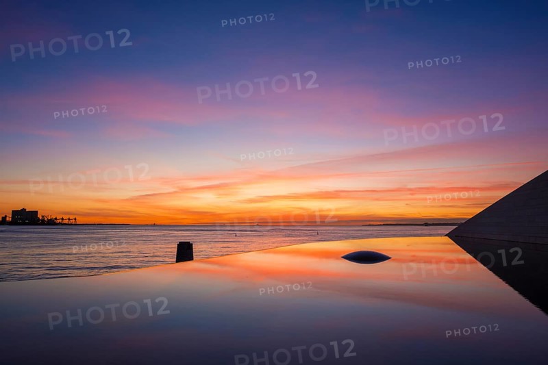 Fountain and pool near the Champalimaud foundation, Portuguese non-profit foundation for scientific medical research in Belem with sunset reflection