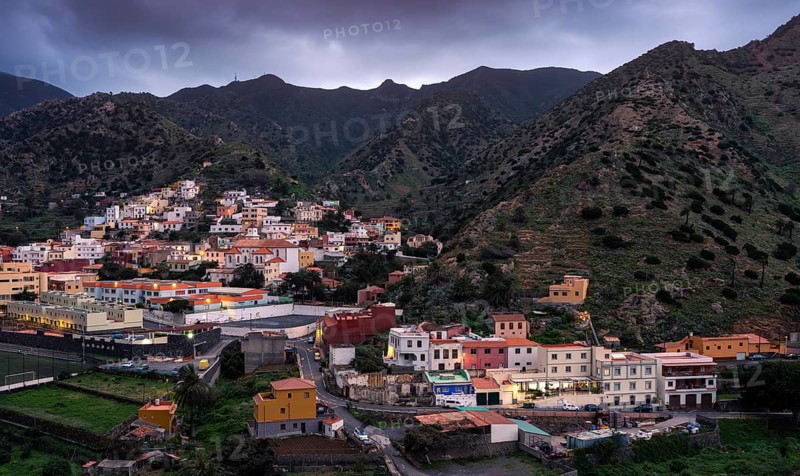 View of Vallehermoso and the surrounding mountain landscape in the evening under a cloudy sky. Vallehermoso, La Gomera, Canary Islands, Spain, Europe