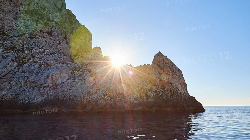 Evening light, sunset, sun as star, sun behind rocks, Marettimo, Egadi Islands, Sicily, Italy, Europe