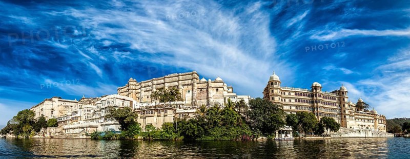 India luxury tourism concept background, panorama of Udaipur City Palace from Lake Pichola. Udaipur, India, Asia
