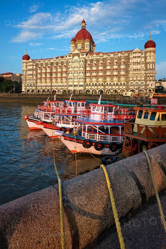 MUMBAI, INDIA, OCTOBER 31, 2019: Tourist boats in front of the famous Taj Hotel in the morning