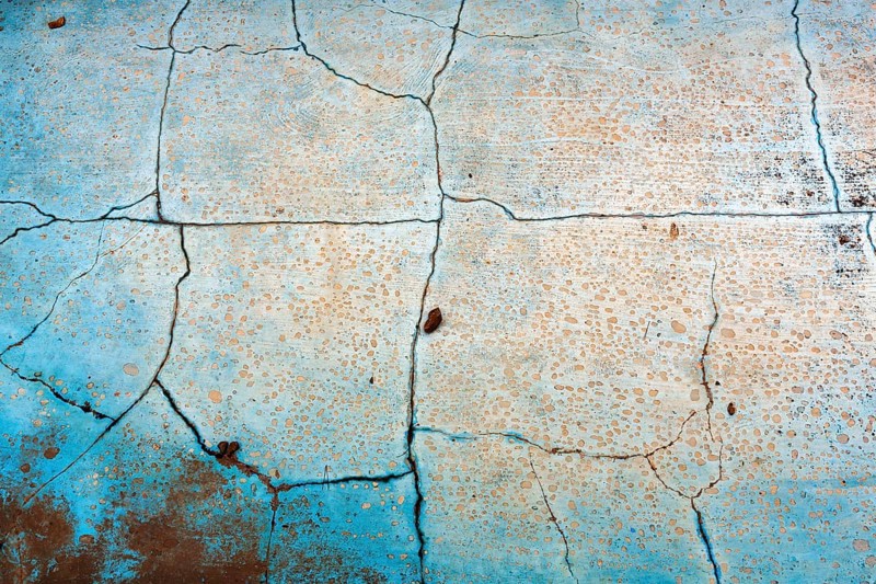Dirty broken floor in a swimming pool, cracks, peeling paint, dilapidated swimming pool, lost place, full-frame, Spain, Europe