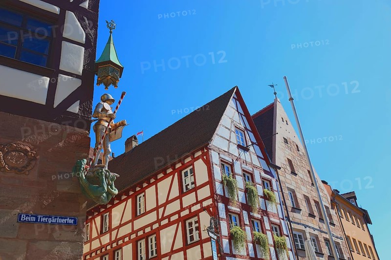 In the historic centre of Nuremberg, St. George as dragon slayer at Pilatus House (left) and houses at Tiergärtnertorplatz, Middle Franconia, Bavaria, Germany, Europe