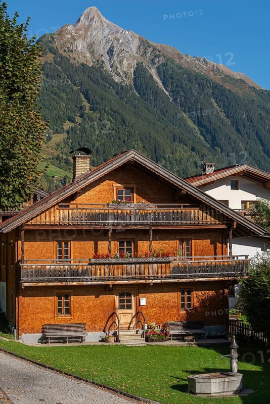Farmhouse, wooden architecture, front, well, balcony, village Brandberg, district Schwaz, Zillergrund, rear Zillertal, Brandberger Kolm (2.700m), Zillertal Alps, blue sky, Tyrol, Austria, Europe