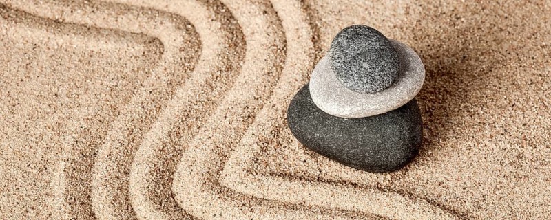 Japanese Zen stone garden, relaxation, meditation, simplicity and balance concept, letterbox panorama of pebbles and raked sand tranquil calm scene
