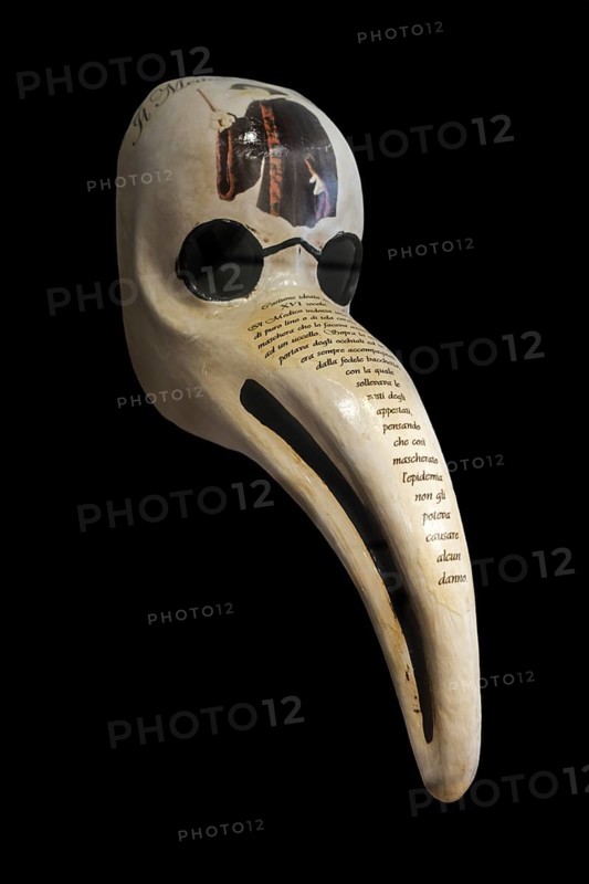 Close-up of Italian bird-like beak mask for plague doctor to treat victims of bubonic plague during epidemic, made of papier-mâché on black background
