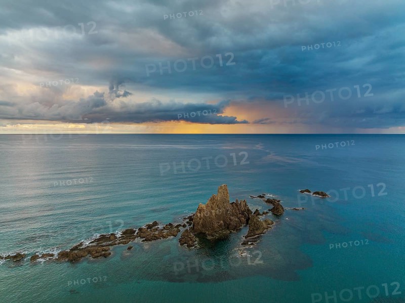 The reef Arrecife de las Sirenas in the Nature Reserve Cabo de Gata-Nijar, at sunrise with heavy showers in the distance, aerial view, drone shot, Almería province, Andalusia, Spain, Europe