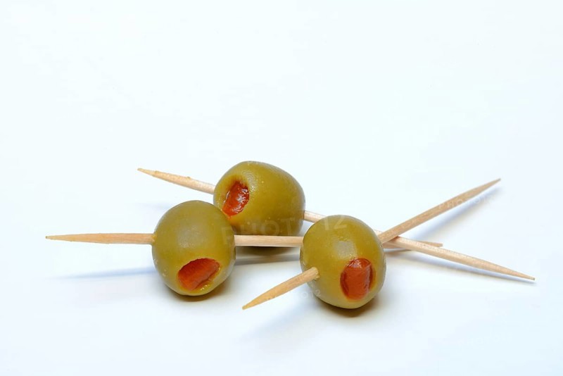 Green olives on toothpicks, stuffed with pieces of paprika