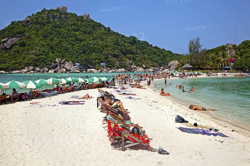 Western tourists sunbathing on beach of Ko Nang Yuan, Nangyuan, small island near Ko Tao along the Central Gulf Coast in Southern Thailand