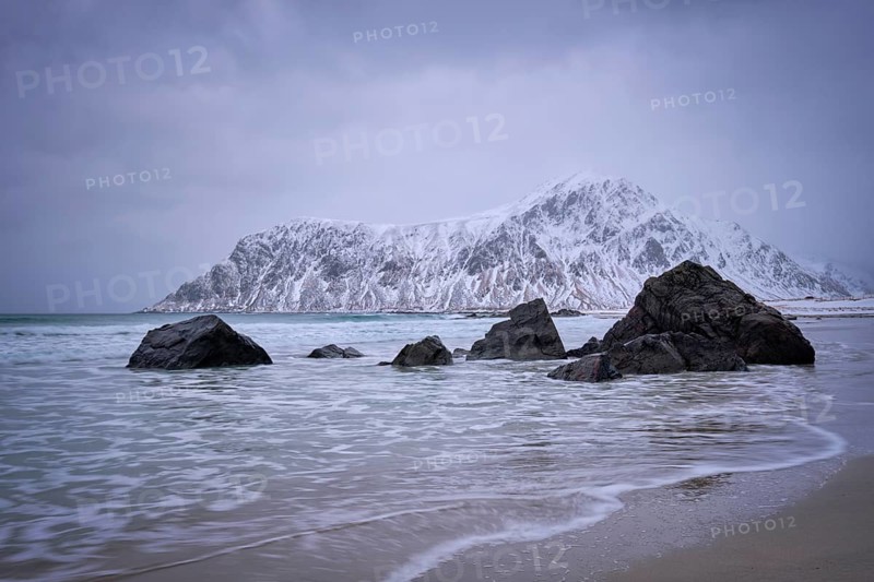 Waves on coast of Norwegian sea in fjord. Skagsanden beach, Flakstad, Lofoten islands, Norway. Long exposure motion blur