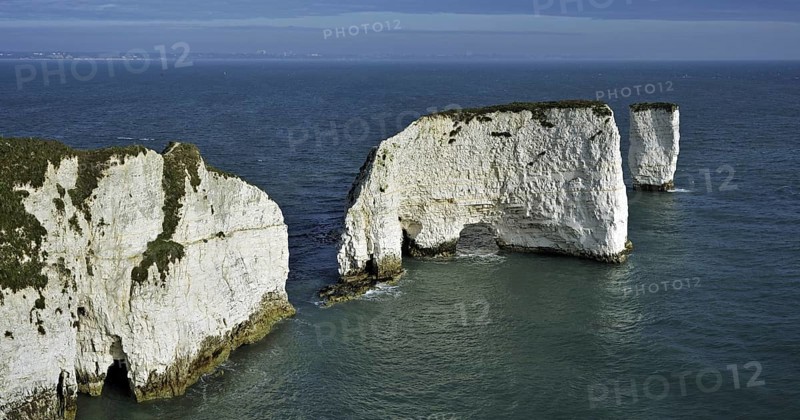 The chalk sea stacks Old Harry Rocks at Handfast Point on the Isle of Purbeck along the Jurassic Coast in Dorset, southern England, UK