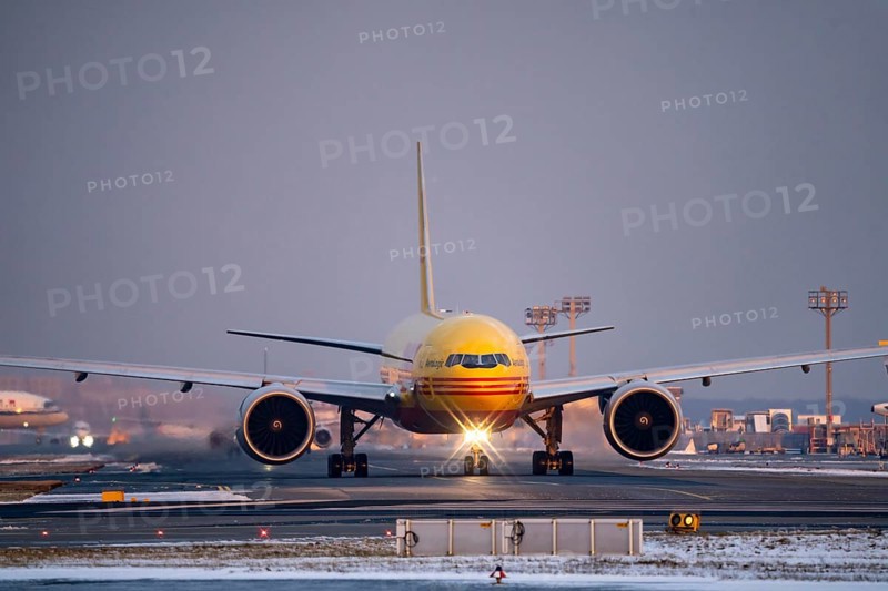 DHL, AeroLogic, Boeing 777F, on the taxiway to Runway West, Frankfurt FRA Airport, Fraport, in winter, Hesse, Germany, Europe