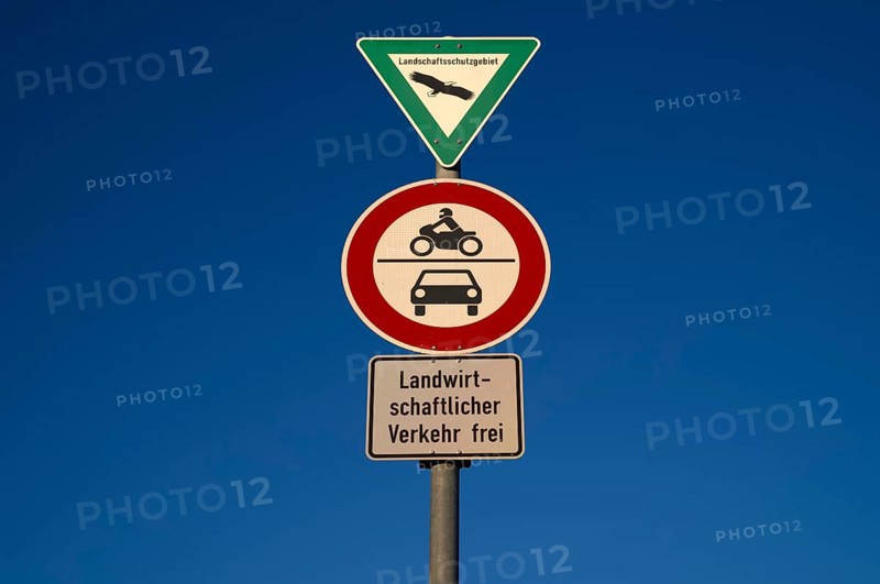 Traffic sign, landscape protection area, prohibition for motorbikes, also with sidecar, mopeds, mopeds as well as for motor vehicles and other multi-lane motor vehicles. Exception agricultural traffic free, in front of sky, blue, Stuttgart, Baden-Württemberg, Germany, Europe
