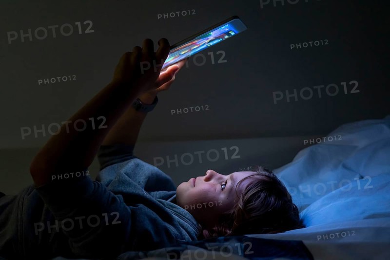 A boy plays computer games on a tablet PC