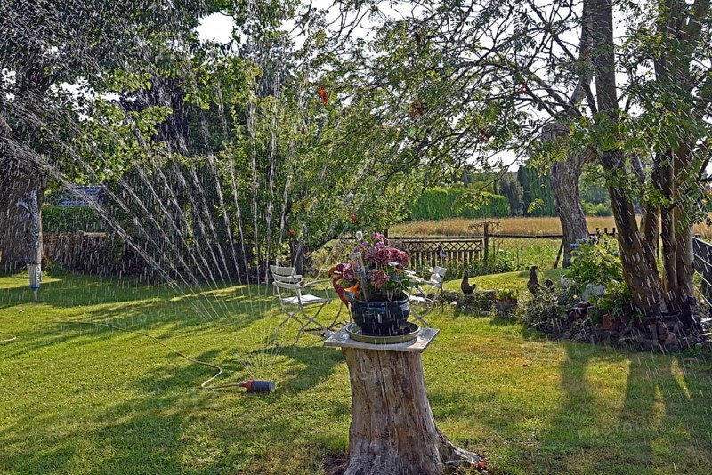 Europe, Germany, Lower Saxony, Stade district, garden in summer, garden table, water sprinkler, Europe