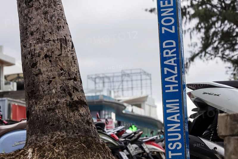 Tsunami Hazard Zone. Warning sign, signposting of escape routes in the event of another seaquake. Beach area and coastal road in the town of Patong, Kathu, Phuket Island, Thailand, Asia