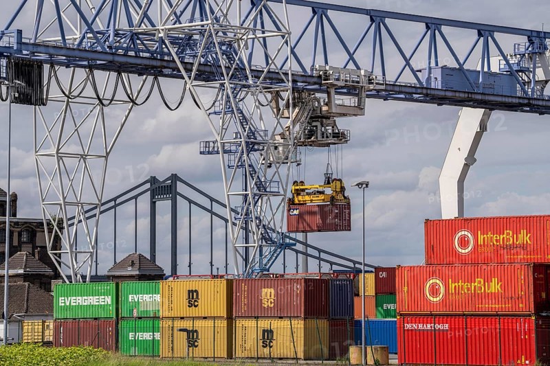 Container terminal at the Rhine port of Krefeld, inland port, 4th largest public port in North Rhine-Westphalia, trimodal handling of goods, goods, containers, general cargo, in the background the Krefeld-Uerdingen bridge over the Rhine, North Rhine-Westphalia, Germany, Europe
