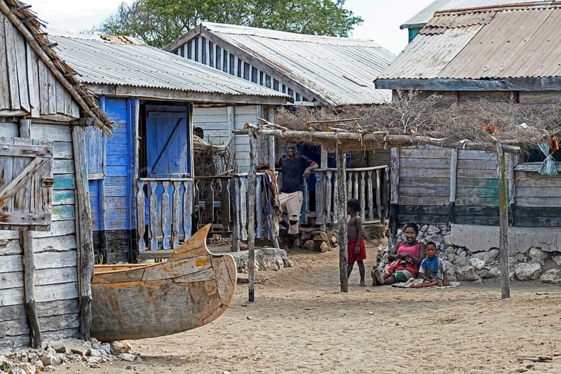 Malagasy family posing among wooden houses in fishing village on the west coast, Atsimo-Andrefana Region, Madagascar, Africa