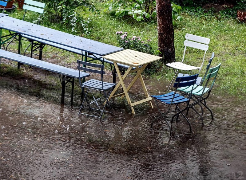 Flooded garden with tables and chairs, Berlin, 23 06 2023