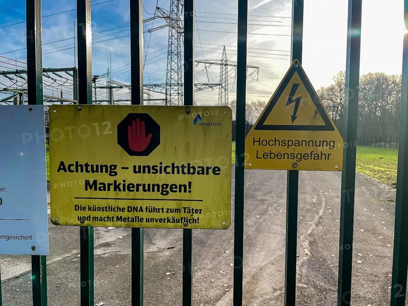 Sign with warning for metal thieves against theft of metal Metal theft on fence gate gate access of substation, Germany, Europe