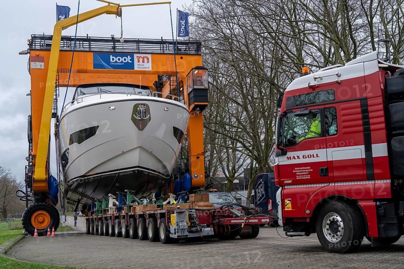 Craning the €6.3 million Sunseeker 88Y motor yacht, weighing 82 tonnes, in preparation for the world's largest water sports trade fair, Boot in Düsseldorf, luxury yachts are driven across the Rhine to the trade fair and brought ashore with the help of the Big Willi ship crane and transported to the exhibition halls on a low-loader, North Rhine-Westphalia, Germany, Europe