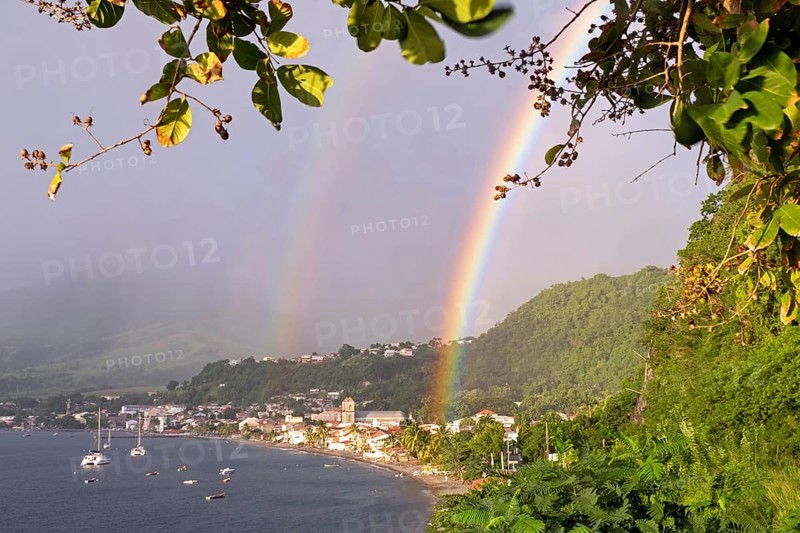 Double rainbow over beach and the town Saint-Pierre, first permanent French colony on the island of Martinique in the Caribbean Sea