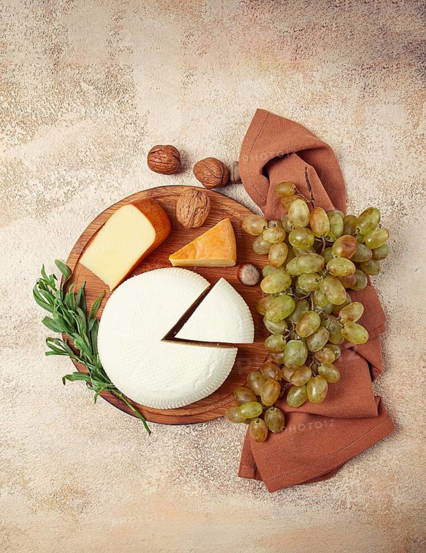 Georgian cheese, Imeretian and smoked suluguni, grapes, nuts, on a cutting board, Georgian cuisine, no people