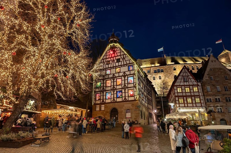 Historic Pilkatushaus with an Advent calendar on 18 December 2024 at dusk, behind the Imperial Castle, Tiergärtnertorplatz, Nuremberg, Middle Franconia, Bavaria, Germany, Europe