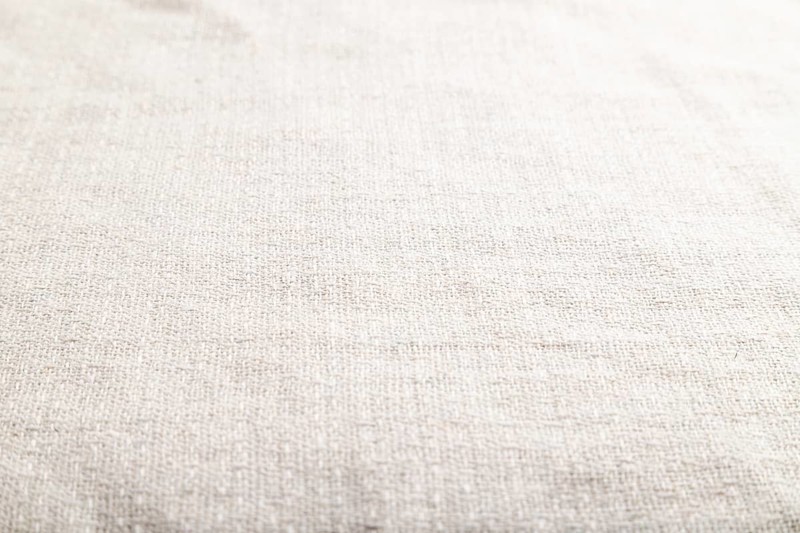 Fragment of smooth white linen tissue. Side view, natural textile background and texture